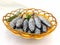 Fresh Small Tuna Fish Decorated with herbs on a bowl White Background.Selective focus