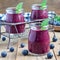 Fresh smoothie with blueberry, plum, mint and basil, square