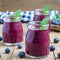 Fresh smoothie with blueberry, plum, mint and basil, square