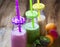 Fresh smoothies in bottles in three colors: green with spinach a