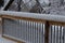 Fresh snow coating railing on a deck