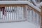 Fresh snow coating railing on a deck and stair case