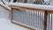 Fresh snow coating railing on a deck and stair case