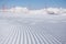 Fresh snow groomer tracks on a ski piste