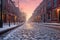 fresh snowfall on empty cobblestone street at dawn