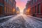 fresh snowfall on empty cobblestone street at dawn