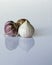 Fresh Solo garlic bulbs which are used for cooking on a white ba