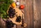 Fresh spiced kitchen herbs in bunches, yellow and red tomatoes, onions and garlic, a knife and cutting Board on an wooden table.