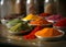 Fresh spices and herbs in bowls on market table. Close up healthy seasoning food backdrop