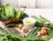 Fresh spinach in old copper pan with oil bowl and nutmeg grater , preparation