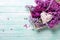 Fresh splendid lilac flowers on tray and white decorative hear
