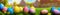 Fresh spring background with easter eggs banner green juicy meadow. Colored Easter eggs hidden