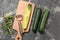 Fresh squashes with peeler on grey background