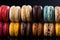 Fresh Stack of three multicolored Macaron or Macaroons on Black background, pastel colors, stacked, colorful, cafe desserts. Rows