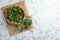 Fresh stinging nettle leaves on white marble table, top view. Space for text