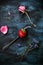 Fresh strawberrie in spoon and some flowers around on dark blue and black background