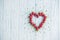 Fresh strawberries array heart shape on old wooden background