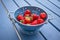 Fresh strawberries in a blue colander on the table
