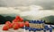 Fresh strawberries and blueberries in a bamboo basket. Berries are placed on a wooden surface. It has a background of intricate