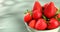 fresh strawberries in a bowl. sweet berry on the table. strawberry harvest closeup