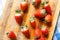 Fresh strawberries in a bowl on wooden table