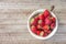 Fresh strawberries in a bowl on wooden table,Red strewberry prepatation to make Strawberry Juice.Healthy and delicious organic