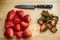 Fresh strawberries on a chopping board sliced with a knife