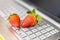 Fresh strawberries on laptop keyboard