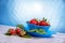 Fresh strawberries in mycelium on a wooden table in blue background