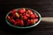 Fresh strawberries on a plate against black background