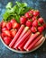 Fresh Strawberries and Rhubarb on Plate with green leaves