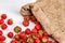 Fresh strawberries scattered on white background.