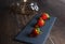 Fresh strawberries still life on slate plate with glass jar and stale base