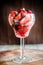 Fresh strawberries under chocolate topping in the glass