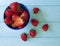 Fresh strawberry dish on a blue wooden background