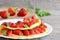 Fresh strawberry egg omelette. Omelette filled with strawberries slices and garnished with mint leaves on a plate