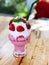 Fresh strawberry smoothie in glass whipped cream and mint leaf on top