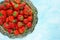 Fresh strawberry on vintage tray on blue background blank space