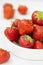 Fresh strawberry on white background in white bowl, fresh fruits for breakfast or healthy food snack