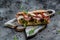 Fresh submarine sandwich with prosciutto ham, sun-dried tomatoes, gherkins, parmesan and arugula. banner, menu, recipe place for
