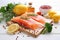 fresh and succulent salmon fillet placed on wooden board, surrounded by array