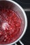 Fresh Summer Berries, Healthy food. Thawing Process of Frozen Raspberries in the Saucepan on the Cooking hob for Cake.