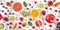 Fresh summer fruit panorama, a flatlay on a white background, vibrant food pattern