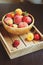 Fresh summer fruits on wooden plate. Strawberries, peaches and apricots