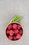 Fresh summer raspberry in a wooden bowl. Top view.