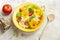 Fresh summer salad with edible flowers nasturtium, borage flowers in a yellow ceramic bowl