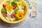 Fresh summer salad with nasturtium flowers,tomatoes and lemones in yellow ceramic bowl
