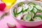 Fresh summer salad with radish cucumbers onion dill and olive oil in a bowl