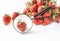 Fresh summer strawberries on a white background under a magnifying glass. The concept of healthy food and environmentally friendly