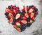 Fresh, summery heart, formed from different berries like strawberries, blackberries, raspberries and blueberries